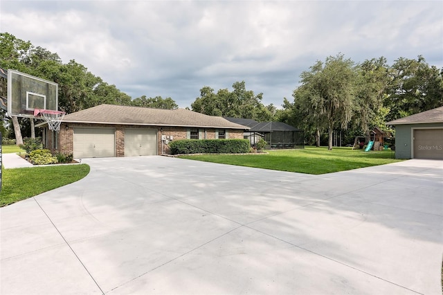 2331 D R Bryant Rd, Lakeland, FL 33810 - view of front facade with driveway, a playground, an attached garage, a front yard, and brick siding