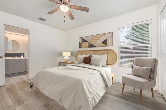113 Patrick Henry Rd, Bartow, FL 33830 - bedroom with light wood finished floors, ensuite bath, and ceiling fan