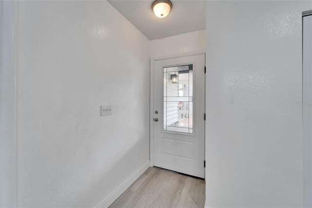 113 Patrick Henry Rd, Bartow, FL 33830 - doorway to outside featuring light wood-style flooring and baseboards