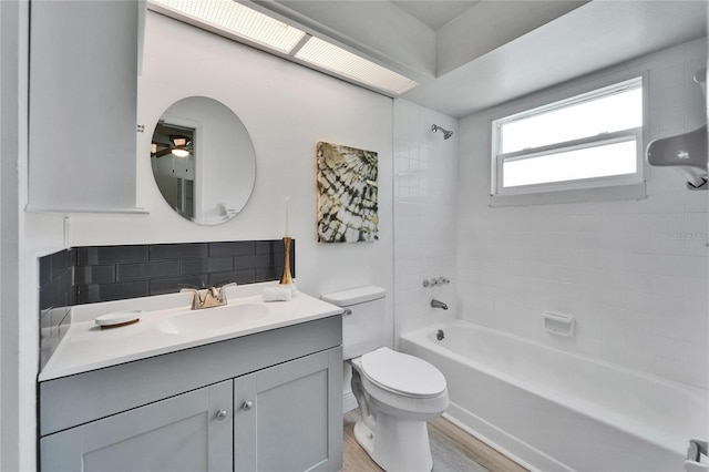 113 Patrick Henry Rd, Bartow, FL 33830 - bathroom featuring bathtub / shower combination, vanity, wood finished floors, and ceiling fan