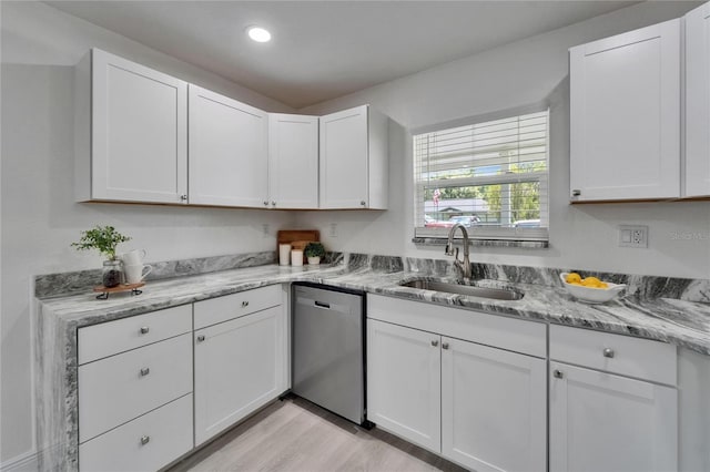 113 Patrick Henry Rd, Bartow, FL 33830 - kitchen with stainless steel dishwasher, white cabinetry, light wood-style flooring, light stone counters, and recessed lighting