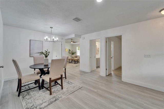 113 Patrick Henry Rd, Bartow, FL 33830 - dining room featuring a chandelier, light wood finished floors, and a ceiling fan