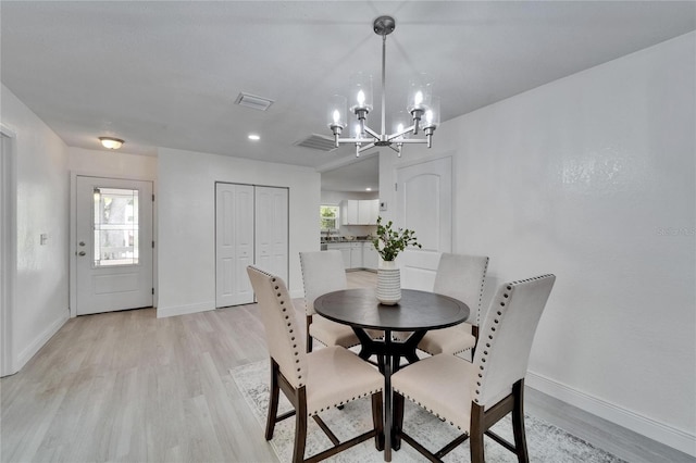 113 Patrick Henry Rd, Bartow, FL 33830 - dining space with light wood finished floors and a chandelier