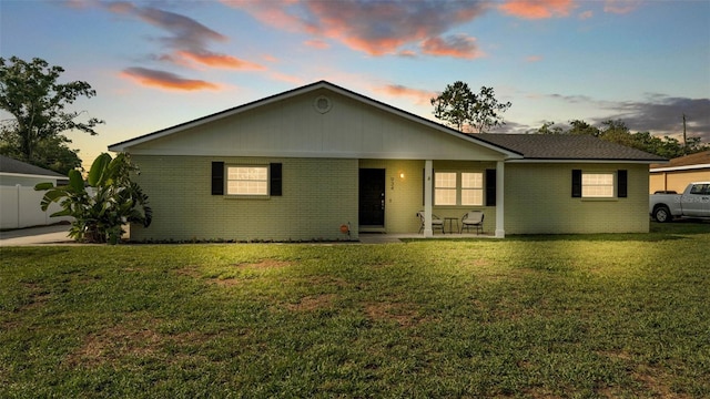 934 Point View Ln, Lakeland, FL 33813 - ranch-style home featuring brick siding, a patio, and a front lawn
