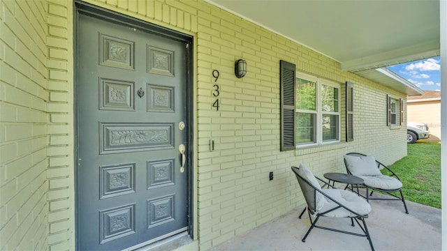 934 Point View Ln, Lakeland, FL 33813 - view of exterior entry featuring brick siding and a porch