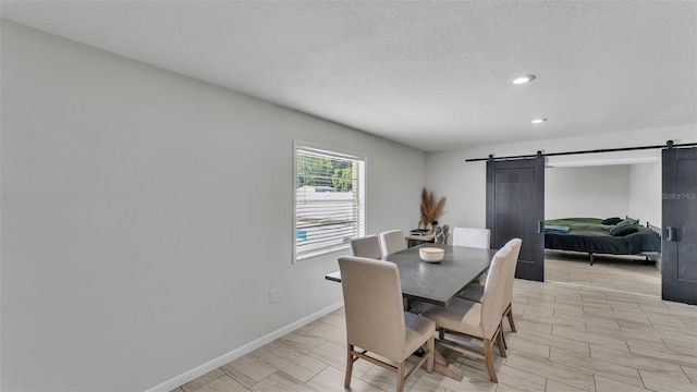 934 Point View Ln, Lakeland, FL 33813 - dining area with a barn door, a textured ceiling, recessed lighting, and baseboards