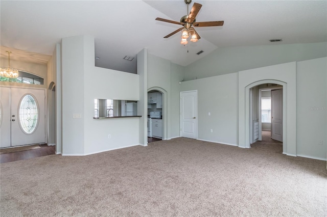 8323 Greystone Dr, Lakeland, FL 33810 - unfurnished living room with arched walkways, carpet flooring, ceiling fan, high vaulted ceiling, and baseboards