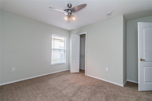 8323 Greystone Dr, Lakeland, FL 33810 - unfurnished bedroom with carpet, baseboards, a closet, and ceiling fan
