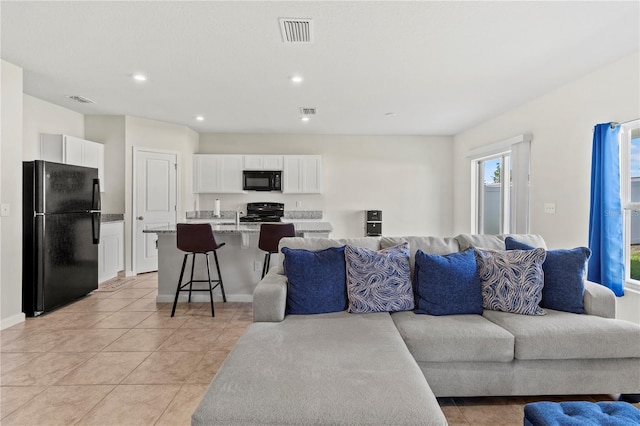 1371 Madison Cir, Haines City, FL 33844 - living area with recessed lighting, baseboards, and light tile patterned floors