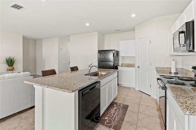 1371 Madison Cir, Haines City, FL 33844 - kitchen with black appliances, a sink, open floor plan, light tile patterned flooring, and recessed lighting