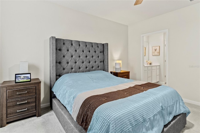 1371 Madison Cir, Haines City, FL 33844 - bedroom featuring light colored carpet, baseboards, connected bathroom, and ceiling fan