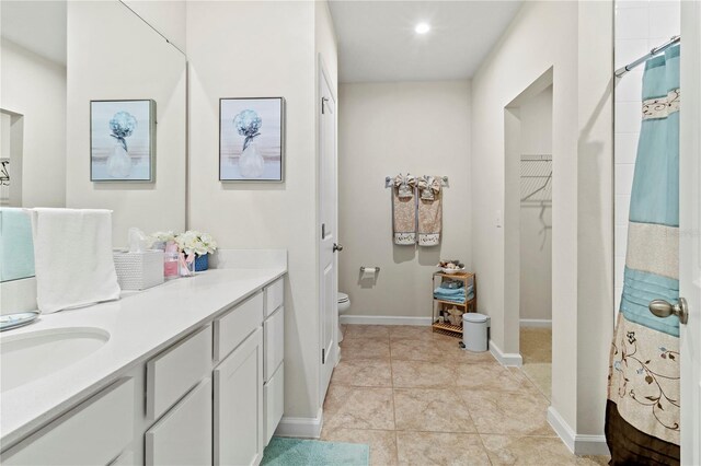 1371 Madison Cir, Haines City, FL 33844 - bathroom featuring toilet, vanity, a closet, tile patterned flooring, and a shower with curtain