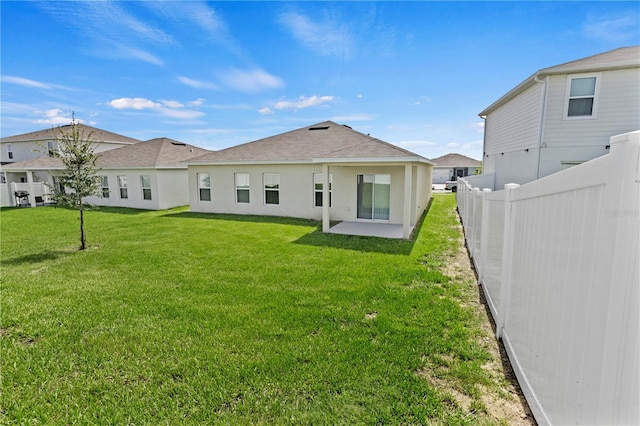 1371 Madison Cir, Haines City, FL 33844 - rear view of house featuring a patio, stucco siding, and a shingled roof