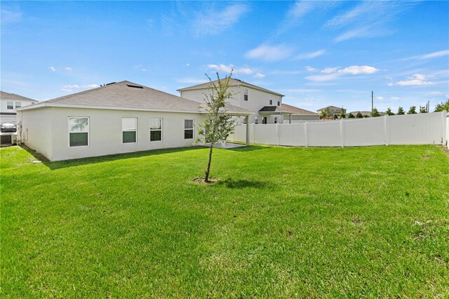 1371 Madison Cir, Haines City, FL 33844 - back of house with stucco siding and roof with shingles