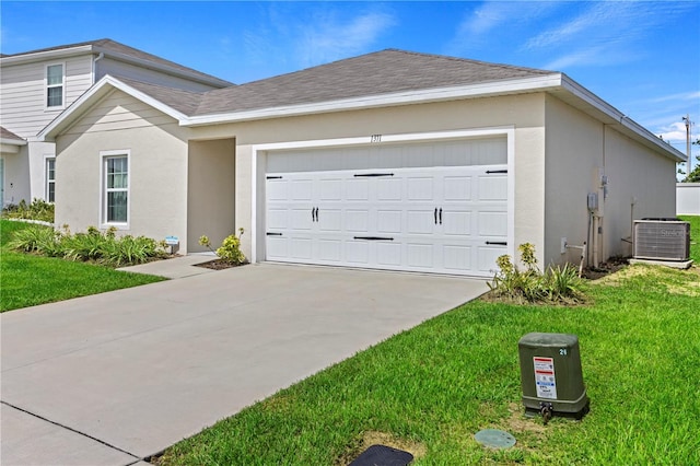 1371 Madison Cir, Haines City, FL 33844 - view of front of house featuring cooling unit, driveway, a garage, and stucco siding