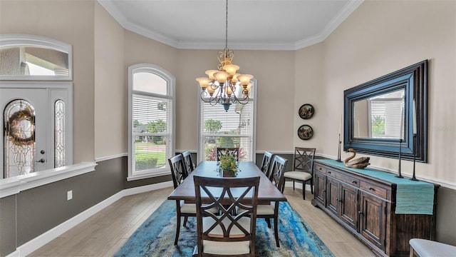 3121 Highlands By The Lake Way, Lakeland, FL 33812 - dining room featuring a chandelier, light wood-type flooring, and ornamental molding