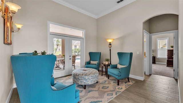3121 Highlands By The Lake Way, Lakeland, FL 33812 - living area with french doors, arched walkways, ornamental molding, and wood finished floors