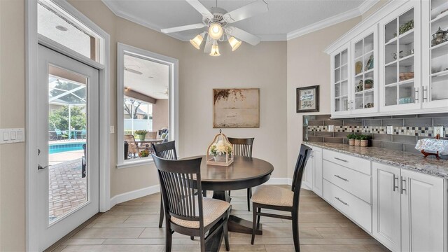 3121 Highlands By The Lake Way, Lakeland, FL 33812 - dining area featuring ornamental molding, light wood-type flooring, and a ceiling fan