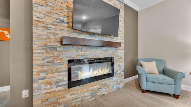 3121 Highlands By The Lake Way, Lakeland, FL 33812 - living room with ornamental molding, wood finished floors, and a fireplace