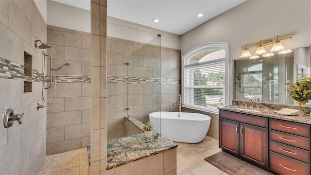 3121 Highlands By The Lake Way, Lakeland, FL 33812 - bathroom with a walk in shower, a freestanding tub, vanity, and recessed lighting