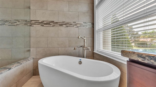 3121 Highlands By The Lake Way, Lakeland, FL 33812 - full bathroom featuring a soaking tub and tile walls