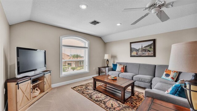 3121 Highlands By The Lake Way, Lakeland, FL 33812 - living area with vaulted ceiling, light colored carpet, ceiling fan, and a textured ceiling