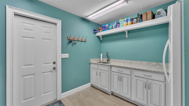3121 Highlands By The Lake Way, Lakeland, FL 33812 - laundry room with a textured ceiling and light wood-style floors