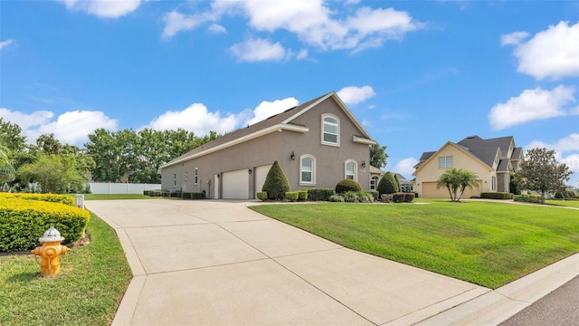 3121 Highlands By The Lake Way, Lakeland, FL 33812 - view of side of home featuring driveway, an attached garage, and stucco siding