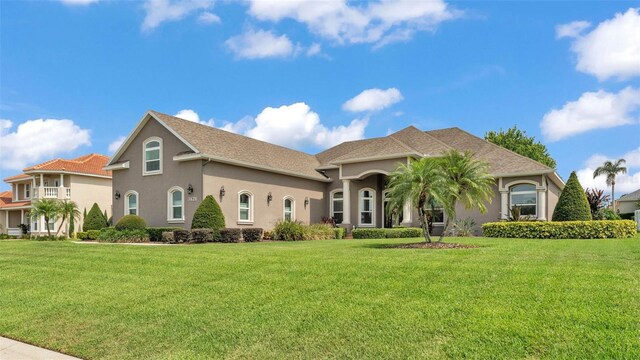 3121 Highlands By The Lake Way, Lakeland, FL 33812 - mediterranean / spanish-style house with stucco siding and a front lawn