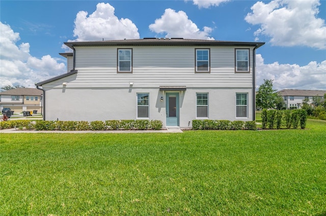 1754 Sanibel Dr, Davenport, FL 33896 - traditional-style house with a front yard and stucco siding
