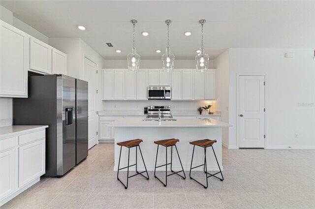 1754 Sanibel Dr, Davenport, FL 33896 - kitchen featuring stainless steel appliances, recessed lighting, light tile patterned floors, light countertops, and white cabinetry