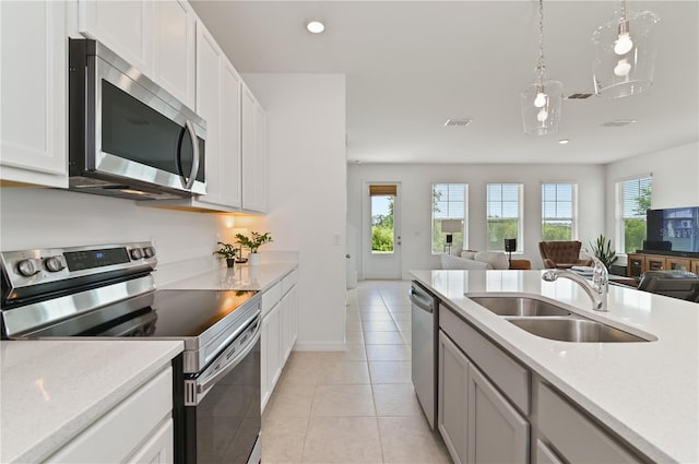 1754 Sanibel Dr, Davenport, FL 33896 - kitchen with appliances with stainless steel finishes, a sink, open floor plan, light countertops, and recessed lighting