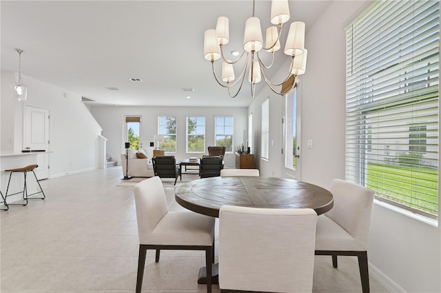 1754 Sanibel Dr, Davenport, FL 33896 - dining space with baseboards, light tile patterned flooring, a chandelier, and stairs