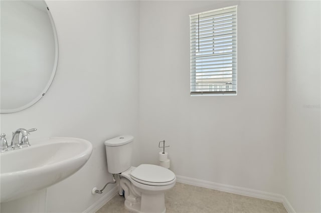 1754 Sanibel Dr, Davenport, FL 33896 - bathroom featuring toilet, baseboards, and a sink