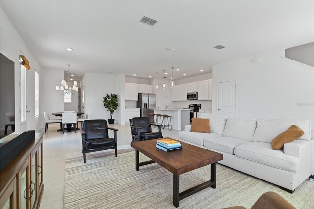 1754 Sanibel Dr, Davenport, FL 33896 - living room featuring a chandelier and recessed lighting