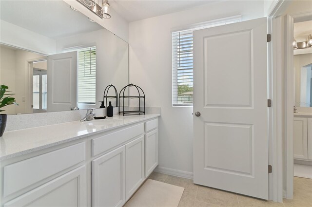1754 Sanibel Dr, Davenport, FL 33896 - bathroom featuring vanity, tile patterned flooring, and baseboards