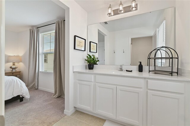 1754 Sanibel Dr, Davenport, FL 33896 - bathroom with vanity, baseboards, and ensuite bathroom