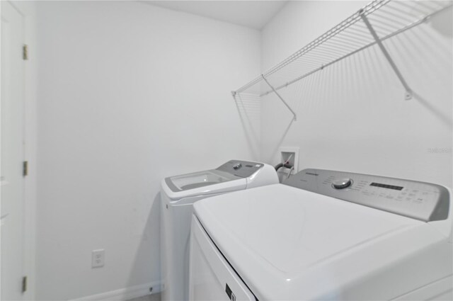 1754 Sanibel Dr, Davenport, FL 33896 - laundry area featuring separate washer and dryer and baseboards