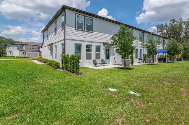 1754 Sanibel Dr, Davenport, FL 33896 - rear view of house featuring a lawn, cooling unit, and a patio