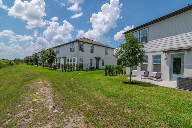 1754 Sanibel Dr, Davenport, FL 33896 - rear view of house featuring cooling unit, a patio, and a yard
