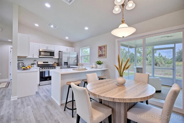 2438 W Wellston Rd, Avon Park, FL 33825 - dining room with light wood-style floors, lofted ceiling, and recessed lighting