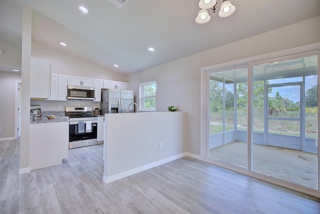 2438 W Wellston Rd, Avon Park, FL 33825 - kitchen with appliances with stainless steel finishes, light wood-type flooring, white cabinets, lofted ceiling, and baseboards