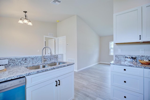 2438 W Wellston Rd, Avon Park, FL 33825 - kitchen with dishwashing machine, a sink, light stone counters, light wood-type flooring, and vaulted ceiling