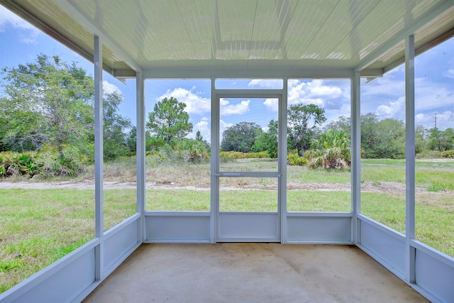 2438 W Wellston Rd, Avon Park, FL 33825 - unfurnished sunroom featuring view of wooded area