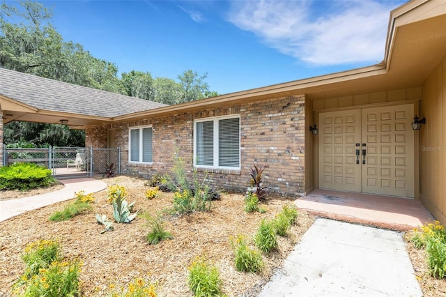 6819 Broken Arrow Trl S, Lakeland, FL 33813 - doorway to property featuring a gate and brick siding