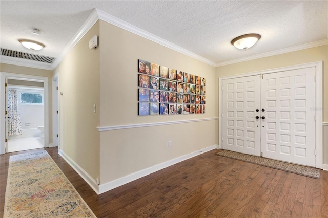 6819 Broken Arrow Trl S, Lakeland, FL 33813 - foyer entrance with a textured ceiling, dark wood-type flooring, and ornamental molding