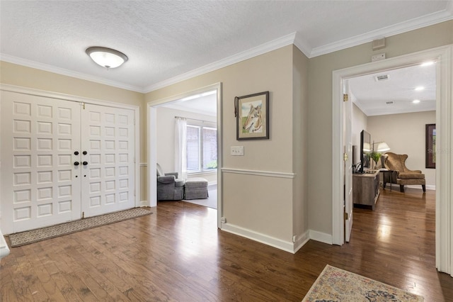 6819 Broken Arrow Trl S, Lakeland, FL 33813 - entrance foyer featuring dark wood finished floors, crown molding, and a textured ceiling