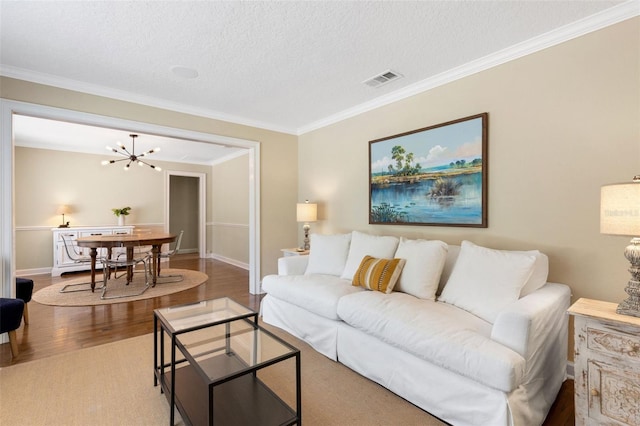 6819 Broken Arrow Trl S, Lakeland, FL 33813 - living area featuring crown molding, wood finished floors, a chandelier, and a textured ceiling