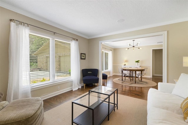 6819 Broken Arrow Trl S, Lakeland, FL 33813 - living room featuring ornamental molding, wood finished floors, a chandelier, and a textured ceiling