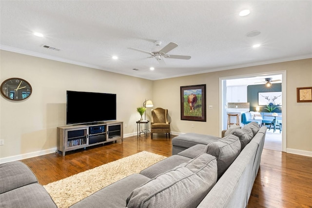 6819 Broken Arrow Trl S, Lakeland, FL 33813 - living area featuring crown molding, a ceiling fan, recessed lighting, and wood finished floors